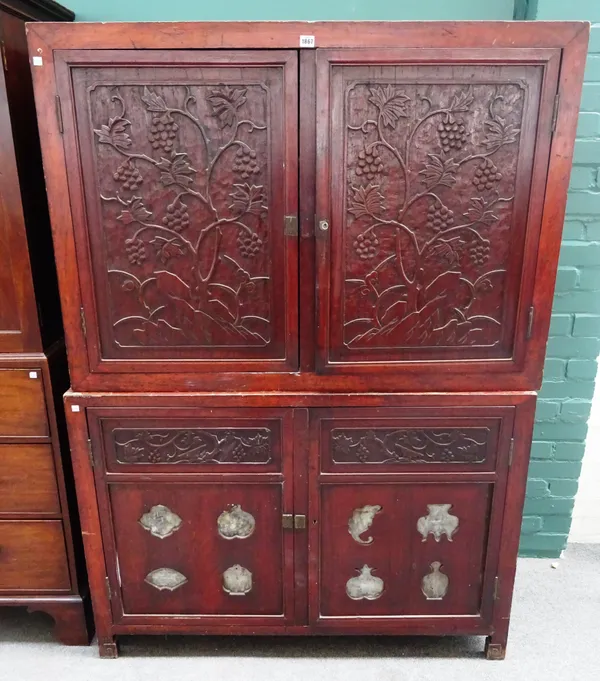 A 19th century Chinese carved camphor double height four door cupboard, with hardstone inset panels, on block feet, 126cm wide x 176cm high x 54cm dee