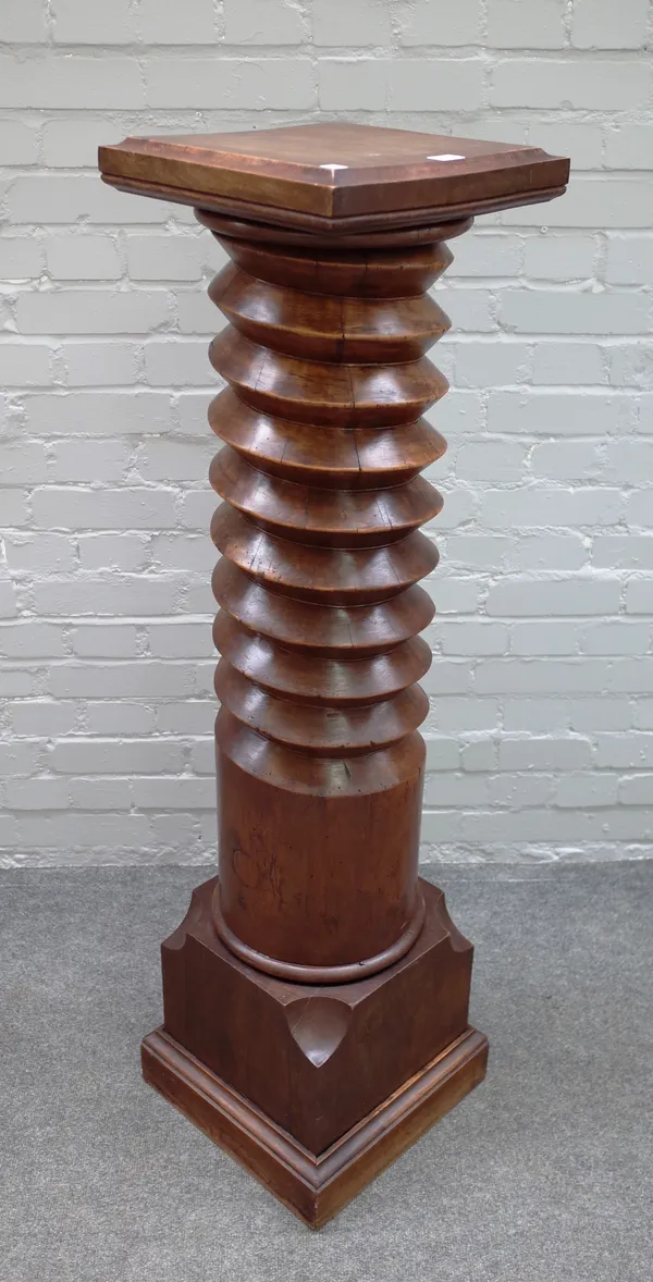 A jardinière stand with square top and base, the column taken form from a carved woodpress worm, 33cm wide x 130cm high.