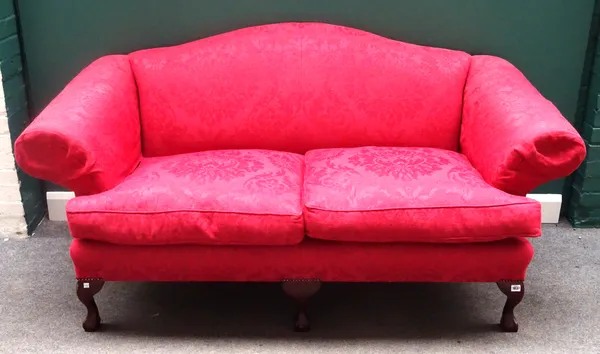 Wesley Barrell; a George I style hump back sofa, with floral patterned red upholstery and roll-over arms, on claw and ball feet, 190cm wide x 96cm hig