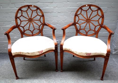 A pair of 20th century "spider web" back open armchairs on tapering square supports, 60cm wide x 95cm high (2).
