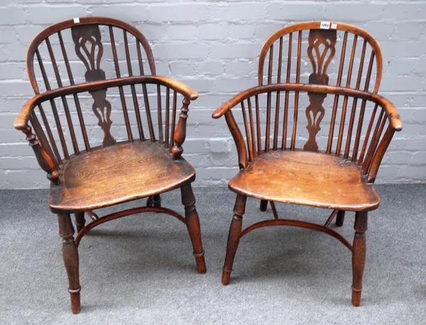 An early 19th century yew and elm bow back Windsor chair on turned supports, united by crinoline stretcher, 60cm wide x 86cm high, together with anoth