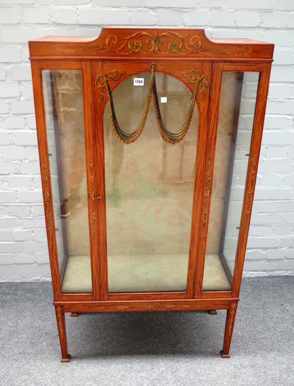 A 20th century floral painted satinwood single door display cabinet, on tapering square supports, 77cm wide x 134cm high x 33cm deep.