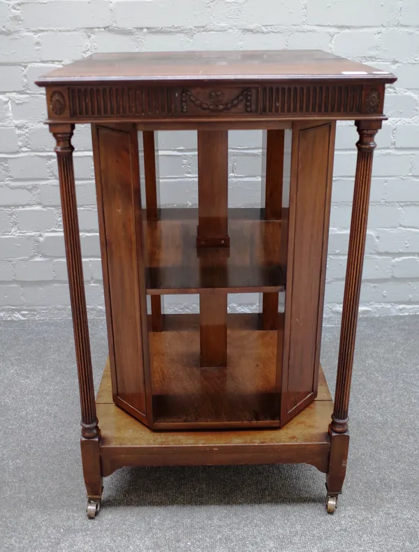 An early 20th century Adam Revival mahogany freestanding bookcase, with square open reeded column frame and revolving centre, 49cm wide x 76cm high.