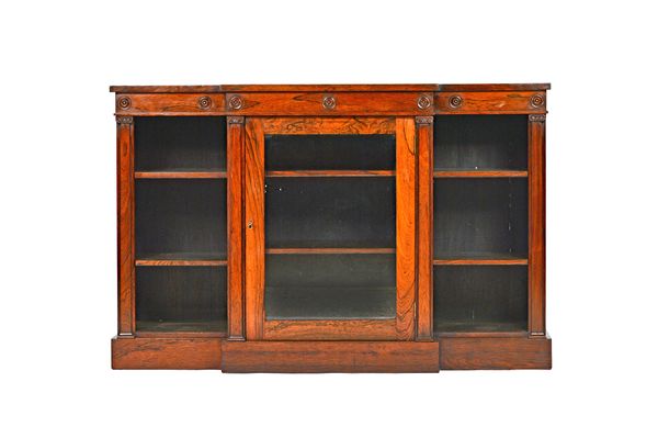 A William IV rosewood floor standing breakfront bookcase, with glazed central door, flanked by open shelves, on plinth base, 141cm wide x 92cm high x