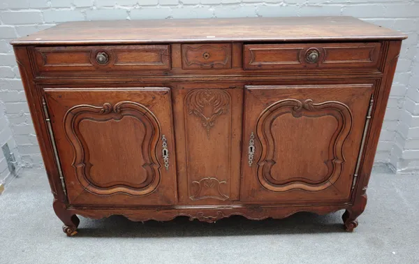 An 18th century French oak buffet with a pair of drawers over pair of shaped panel cupboards on scroll feet, 155cm wide x 101cm high x 58cm deep.