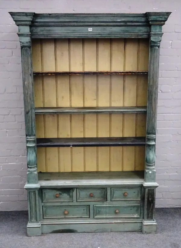 A 20th century oxide green painted bookcase cupboard, the enclosed four tier open back flanked by split reeded columns, over five various drawers on p