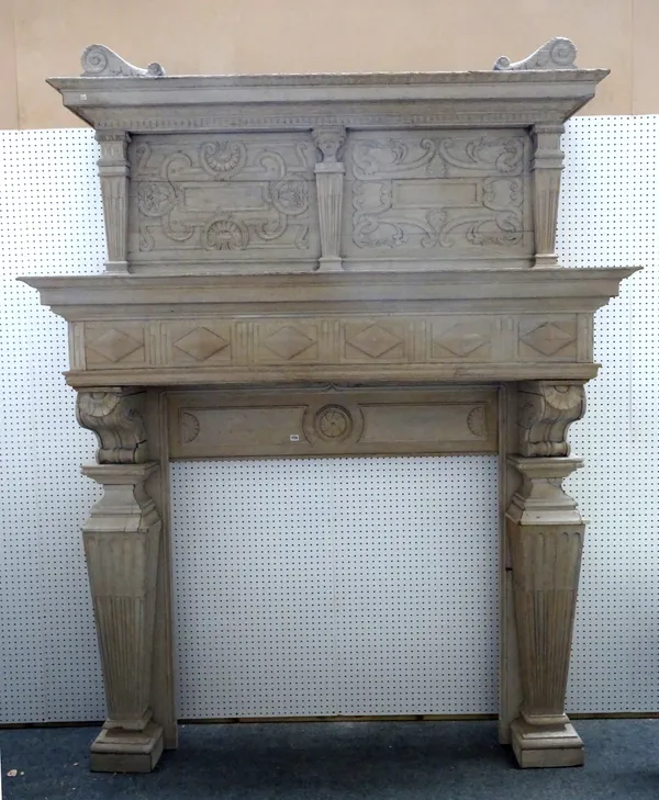 A large early 20th century stripped oak fire surround with blind fret carved frieze and fluted tapering square jambs, 187cm wide x 250cm high, the ape