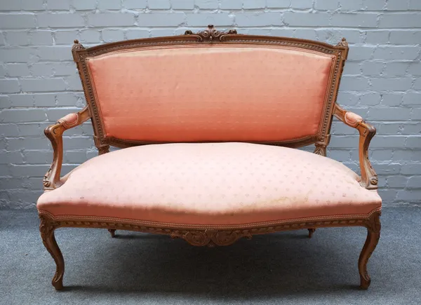 A Louis XV style carved walnut salon suite, to comprise; a sofa 125cm wide x 99cm high, a pair of armchairs, each 63cm wide x 94cm high and four side