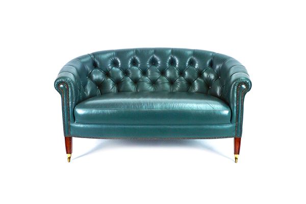 A small George III style green leather upholstered tub back sofa, on tapering square mahogany supports, 133cm wide x 69cm high.