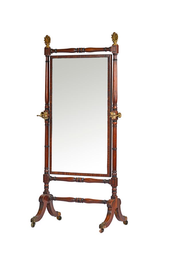 An early 19th century mahogany cheval mirror, with twin candle sconce mounted turned columns and four downswept supports, 85cm wide x 182cm high. Illu