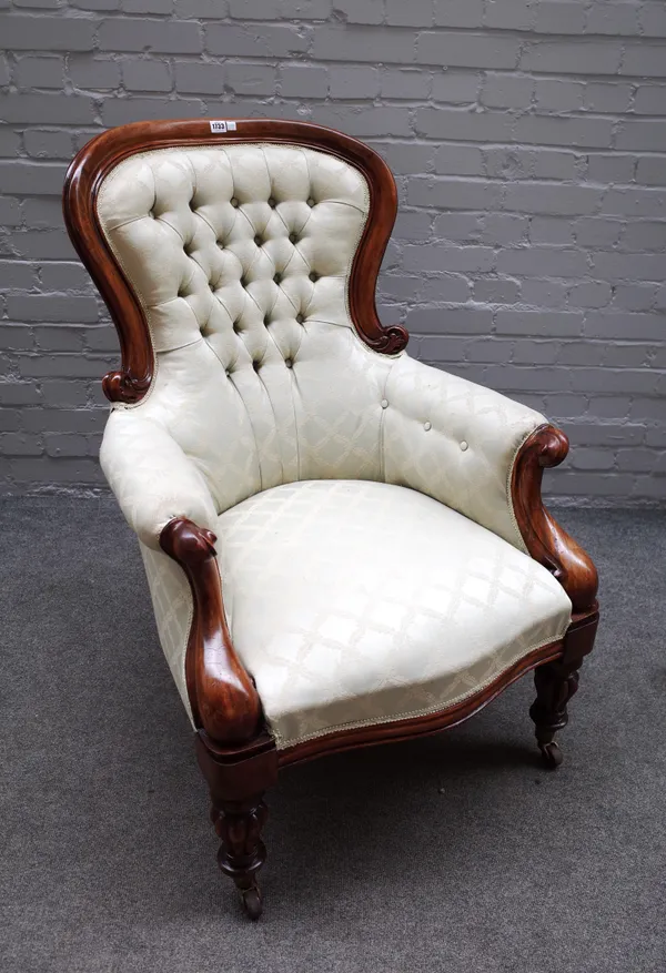 An early Victorian mahogany framed spoon back armchair on reeded baluster supports, 73cm wide x 104cm high.