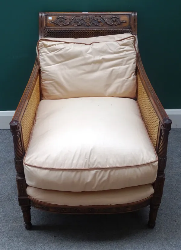 A late 19th century carved mahogany famed easy armchair, with double bergere panels on carved and spiral fluted supports, 65cm wide x 85cm high.