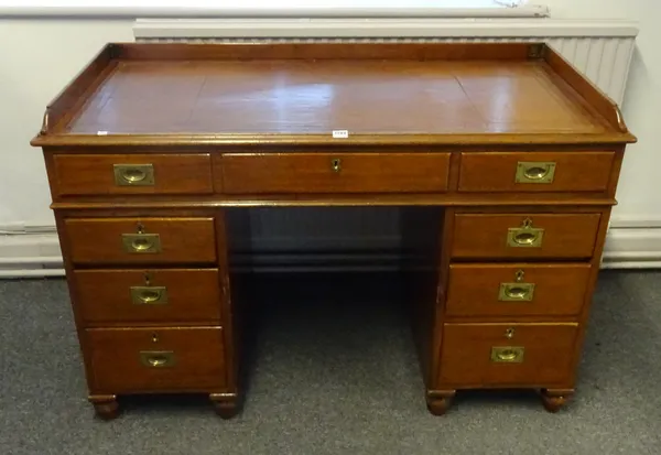A 19th century mahogany campaign desk, the folding three-quarter gallery over nine drawers about the knee, on turned feet, the top to each pedestal st