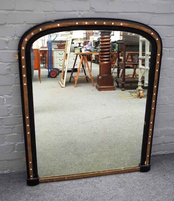 A 19th century Irish style arch top overmantel mirror, the parcel gilt ebonised frame with faceted glass mounts, 97cm wide x 119cm high.