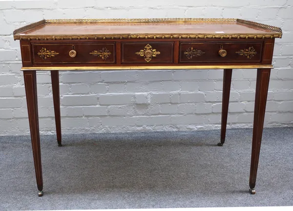 A George III brass inlaid mahogany free standing writing table, the rectangular three-quarter galleried top over three frieze drawers, on tapering squ