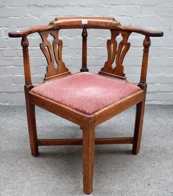 A George II mahogany corner chair with double pierced splat back on block supports, 74cm wide x 76cm high.