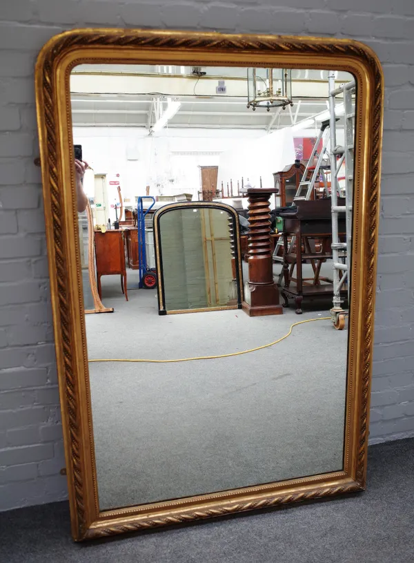 A 19th century gilt framed rounded rectangular overmantel mirror, with dimple mounted rope twist frame, 114cm wide x 168cm high.