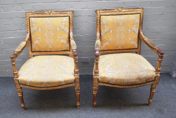 A pair of Louis XVI style gilt framed square back open armchairs on tapering fluted supports, 62cm wide x 91cm high (2).