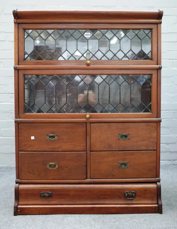 The Globe-Wernicke Co Ltd; a teak framed bookcase, with a pair of leaded glazed sections over four short drawers and one long drawer, 87cm wide x 120c