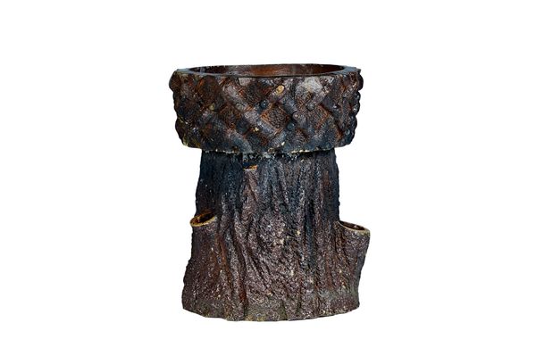 A brown glazed terracotta two part jardinière of naturalistic tree form, 61cm deep x 78cm high. Illustrated