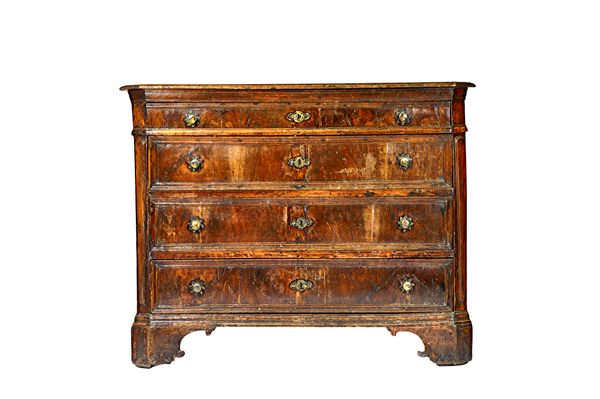 A 17th century North Italian walnut commode, with four long graduated drawers, flanked by canted corners, on bracket feet, 148cm wide x 116cm high x 6