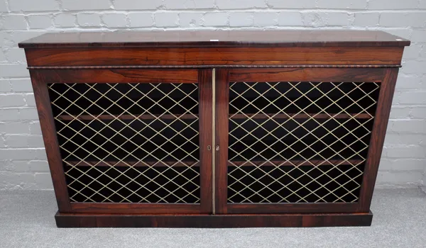 A William IV rosewood floor standing bookcase, with pair of grille doors, on plinth base, 153cm wide x 89cm high x 27cm deep.