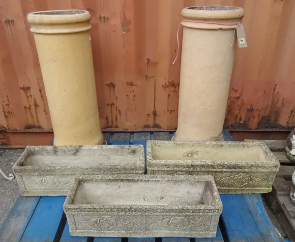 A pair of 20th century stone chimney pots, 80cm high and a group of three 20th century stone planters, 60cm wide x 18cm high, (5).  OUT