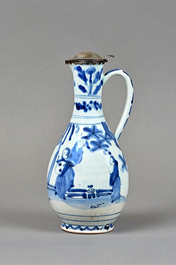 A Japanese Arita blue and white ewer with later Dutch silver mounts, the ewer circa 1700, of slender pear form, painted in Chinese transitional style