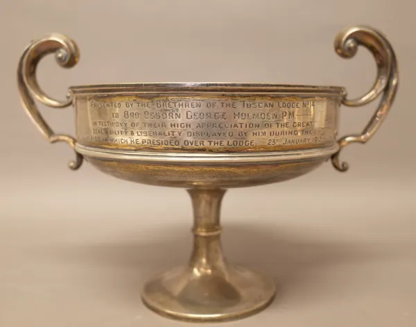 A silver twin handled trophy bowl, presentation inscribed, raised on a circular foot, Chester 1910, weight 710 gms.
