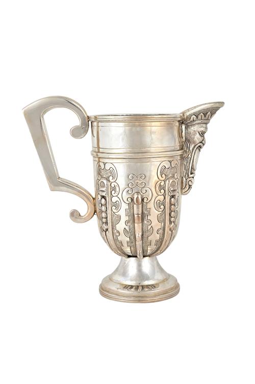 An Italian wine jug, with cast decoration to the mask spout and to the body, in the 18th century taste, raised on a circular foot, with a fitted case,