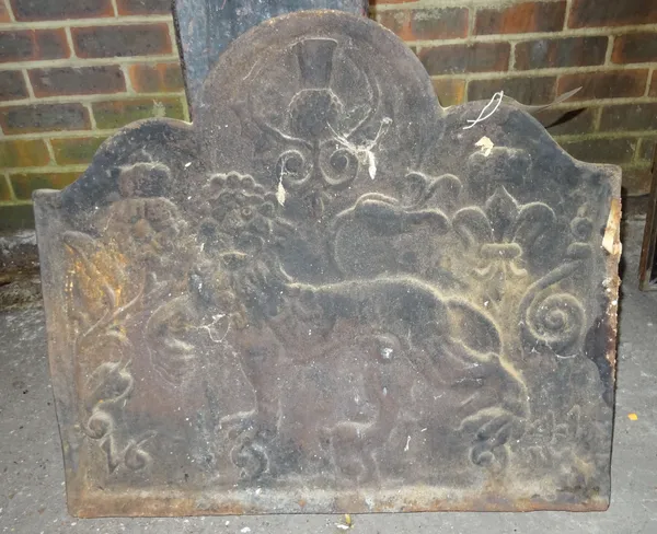 An 18th century cast iron arch top fire back depicting an heraldic lion, 75cm wide x 70cm high.  OUT