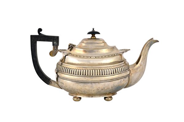 A silver three piece tea set, comprising; a teapot, a twin handled sugar bowl and a milk jug, each piece of compressed oval form, decorated with a flu