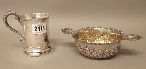 Silver, comprising; a Victorian christening mug, of waisted cylindrical form, with a scrolling handle, raised on a circular foot, London 1851 and a Vi