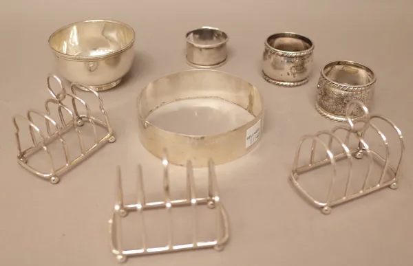 Silver, comprising; a plain circular bowl, London 1964, a pair of napkin rings, Sheffield 1895, another napkin ring and three toastracks, combined wei
