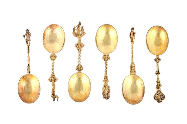 Six silver gilt dessert serving spoons, each with an oval bowl, but with differing handles and finials, in the Dutch taste, London 1912, combined weig