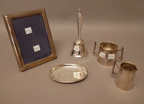 Silver and silver mounted wares, comprising; a twin handled sugar bowl and a matching milk jug, Birmingham 1920, a rectangular photograph frame and a