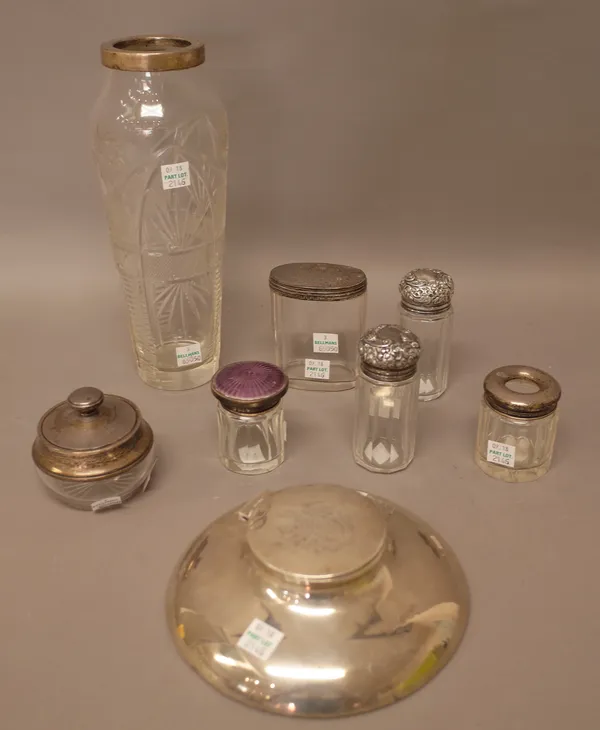 Silver and silver mounted wares, comprising; a circular hinge lidded inkstand, London 1918, a faceted glass vase, a glass hair tidy jar, a glass lidde
