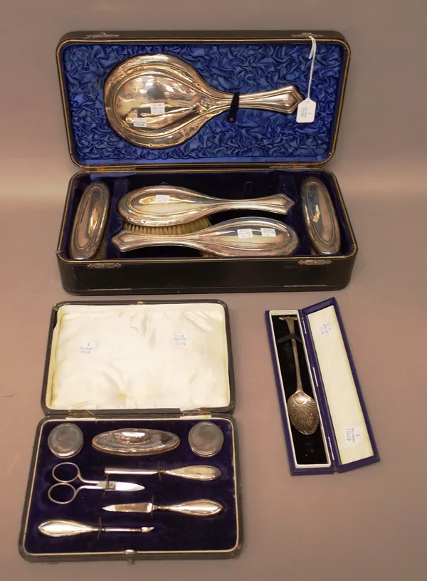 Silver and silver mounted wares, comprising; a lady's five piece dressing set, consisting of a hand mirror, a pair of hair brushes and a pair of cloth