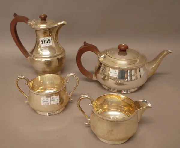A silver four piece tea set, comprising; a teapot, a twin handled sugar bowl and a milk jug, Birmingham 1965 and a hot water jug, Birmingham 1964, the