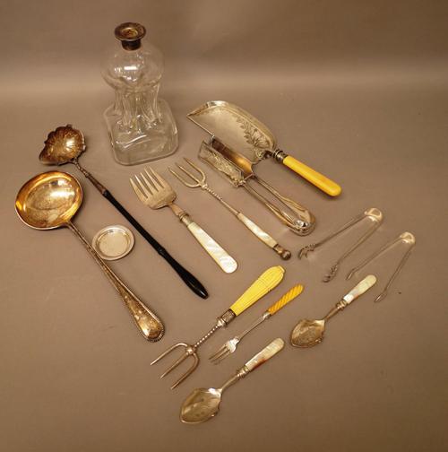 A silver toddy ladle, with a shaped oval bowl, London 1745, with a later ebonised handle, a silver mounted glass dimple decanter, Birmingham 1923, (th