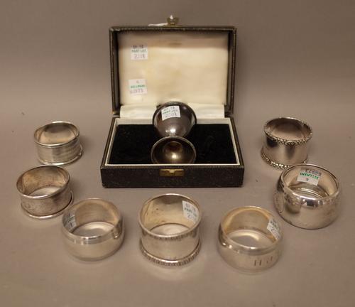 Silver, comprising; a pair of napkin rings, initial engraved by Mappin & Webb, London 1954, five further napkin rings and a christening egg cup, with