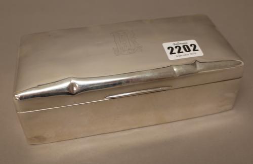 A late Victorian silver rectangular table cigarette box, wooden lined within, the hinged lid monogram engraved, London 1898, length 19.5cm.
