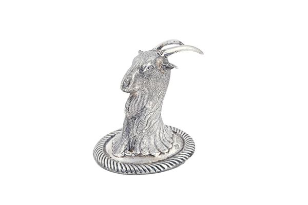 A silver pepperette, designed as the head of a goat, possibly made as a special commission in the form of an armorial crest, on a circular base, with