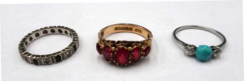 A turquoise and diamond three stone ring, mounted with a turquoise bead between two cushion shaped diamonds, a 9ct gold and red gem set set five stone