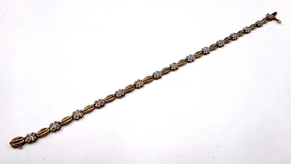 A 9ct gold and diamond set bracelet, the links in a quatrefoil shaped link design, mounted with circular cut diamonds, on a snap clasp, with a foldove