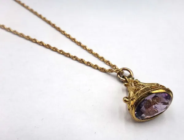 A 9ct gold and amethyst set single stone pendant fob, having ropetwist and wirework decoration, with a 9ct gold ropetwist link neckchain, on a boltrin