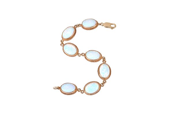 A 9ct gold and synthetic opal bracelet, in an oval link design, mounted with seven synthetic oval opals within ropetwist surrounds, length 18cm and a