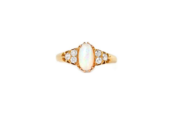 A gold, opal and diamond ring, claw set with the oval opal between diamond three stone shoulders, mounted with cushion shaped diamonds, detailed 18, r