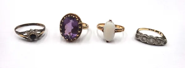 A gold ring, claw set with an oval opal, detailed 18, a 9ct gold ring, claw set with an oval cut amethyst, a gold and colourless gem set five stone ri