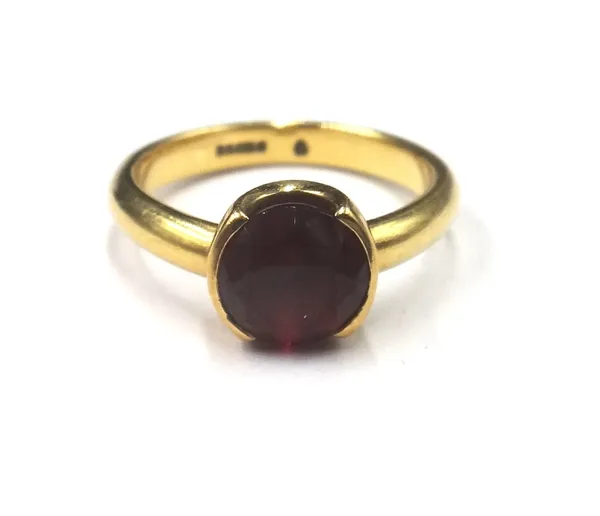 An 18ct gold ring, claw set with a circular cut garnet, ring size K, gross weight 4.7 gms.